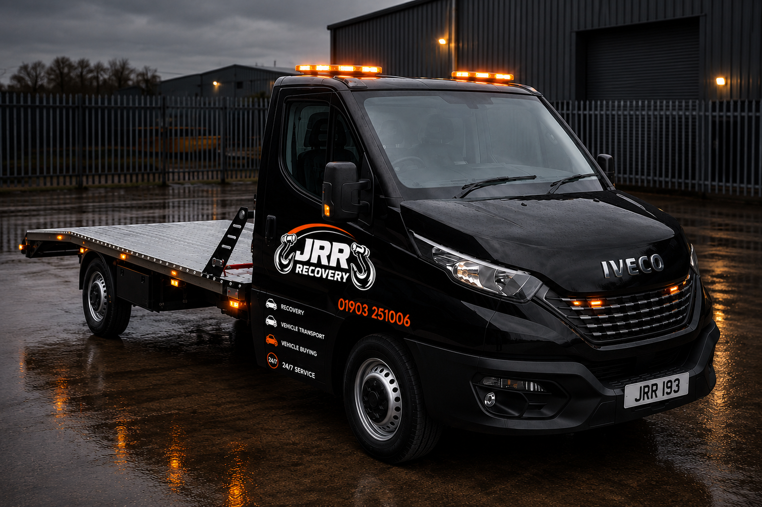 JRR Recovery vehicle transport flatbed truck outside the yard